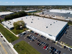 an aerial view of an amazon warehouse with cars parked in front of it